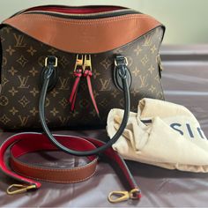 This Gently Used Louis Vuitton Tuileries Shoulder Bag Is A Stunning Addition To Any Fashion-Forward Woman's Collection. The Bag Is Crafted In France With A Caramel/Rouge Leather And Monogram Canvas Exterior, Complemented By Gold-Tone Hardware. The Bag's Rectangular Shape And Double Zip Closure Make It An Ideal Choice For Everyday Casual Use. The Bag Features Bottom Studs, Inner And Outer Pockets, And A Detachable Adjustable Shoulder Strap. The Double Handles Have A 4.5" Drop And Are Black In Color. The Interior Of The Bag Is Lined With Red Alcantara And Includes The Original Dust Bag. This Gently Loved Bag Is In Very Good Condition, Circa 2017, And Is Perfect For Any Fashion-Conscious Woma Used Louis Vuitton, Canvas Shoulder Bag, Handle Bag, Monogram Canvas, Women Collection, Louis Vuitton Bag, Top Handle, Bags Handbags, Fashion Forward