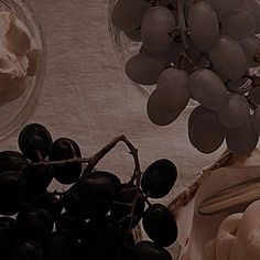 grapes and whipped cream in bowls on a table