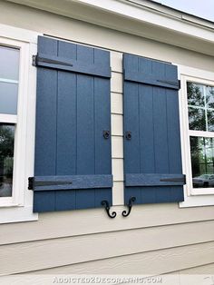 two blue shutters on the side of a house