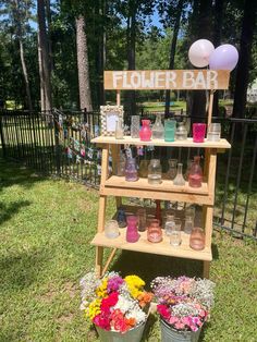 a flower bar is set up outside in the grass