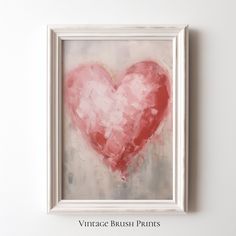 a painting of a red heart in a white frame on the wall above it is an inscription that reads vintage brush prints