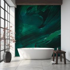 a bath tub sitting next to a window in a room with green paint on the wall