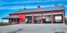 a red barn with two large doors on the side