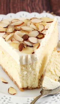 a piece of cake with almonds on top and white frosting in the middle