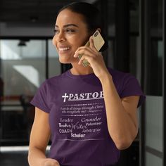 a woman in a purple shirt is talking on her cell phone and smiling at the camera