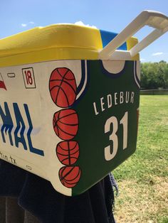 the back of a cooler with basketballs painted on it's sides and handles