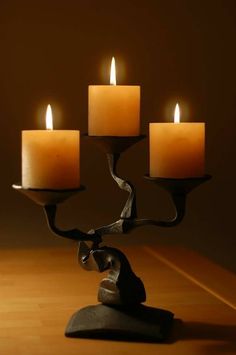 a candle holder with five lit candles in it