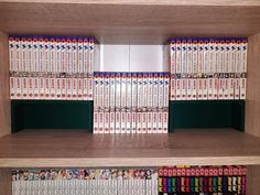 the shelves are filled with many different colored dvd's and dvds in wooden cases