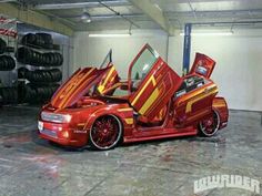 an orange and red car with its doors open