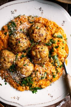 meatballs and pasta on a white plate with parmesan sprinkles