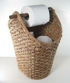 a wicker basket with two rolls of toilet paper in it