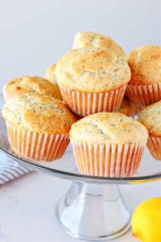 lemon poppy seed muffins on a glass cake plate