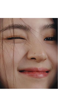 a close up of a woman's face with her eyes closed