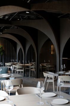 an empty restaurant with white tables and chairs