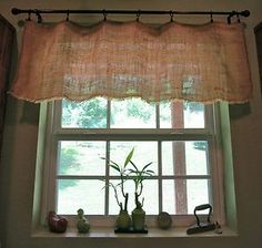 a window sill with a bamboo plant and other decorative items in front of it