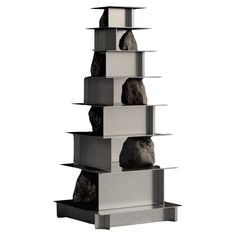 three shelves with rocks stacked on top of each other in front of a white background