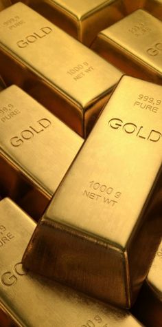 gold bars stacked on top of each other with the word gold written on them in cursive font