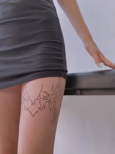 a woman's legs with tattoos on them