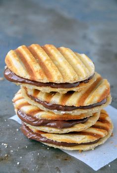 a stack of chocolate covered waffles sitting on top of each other