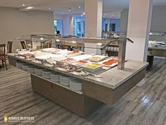 a buffet area with many plates and bowls on the counter