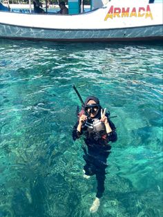 a person in the water with a camera taking a selfie while holding a scuba pole