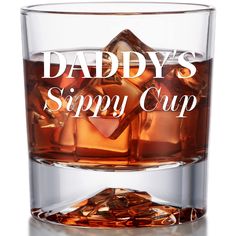 a glass with some ice cubes in it that says daddy's sippy cup