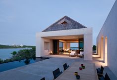 an outdoor dining area with table and chairs