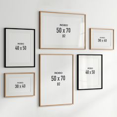 a white wall with black and white framed pictures on it that have the numbers 50 - 70 in them