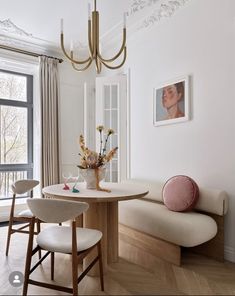 a dining room table with two chairs and a bench