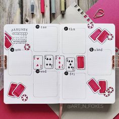 an open planner with playing cards on it