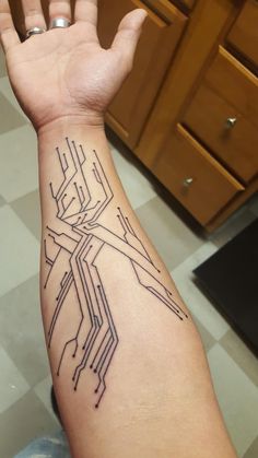 a person's arm with a tattoo on it that has lines in the middle