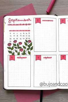 an open planner with flowers on it next to a pink pen and some other items