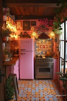 a pink refrigerator freezer sitting inside of a kitchen next to a stove top oven