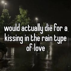 a man standing in the rain next to a car with an umbrella over his head that says, would actually die for a kissing in the rain type of love