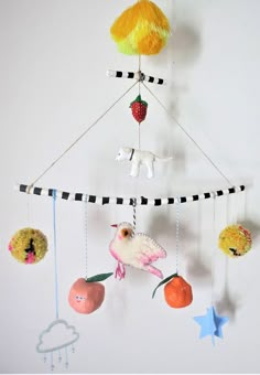 a mobile with fruits and animals hanging from it