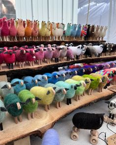 there are many different types of yarns on the shelves in this shop, and one is made out of wood