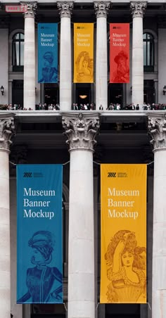 three banners hanging from the side of a building with columns and pillars in front of them