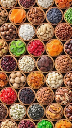 many different types of nuts in wooden bowls