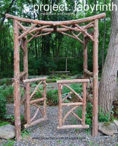 a wooden arbor in the middle of a garden with rocks and trees around it,