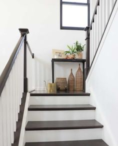 some vases are sitting on the stairs