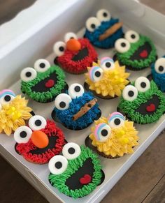 the cupcakes are decorated like sesame street characters