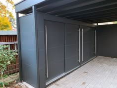 an outdoor covered area with sliding doors and brick pavers flooring in front of it