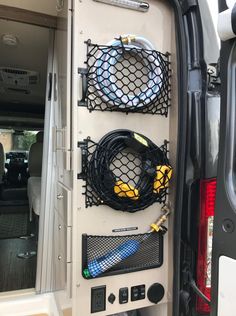 the back end of a van with various items in it