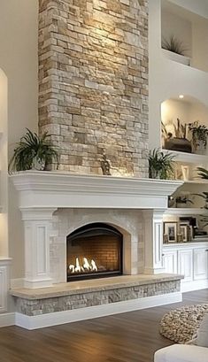 a living room filled with furniture and a fire place in the middle of a wall