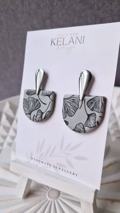 a pair of earrings sitting on top of a card