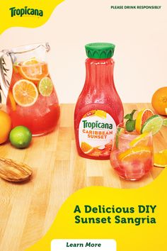 an ad for tropical juice with oranges and lemons on the table next to it