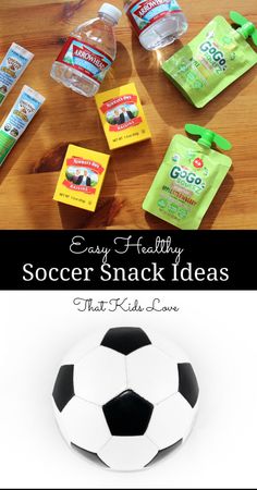 a soccer ball sitting on top of a wooden table next to snacks and water bottles