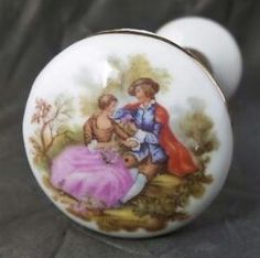 an old fashioned porcelain door knob with a painted image of a man and woman on it