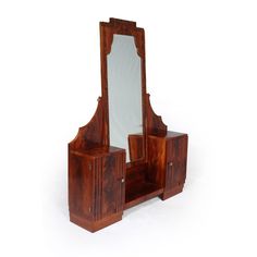 an antique wooden dressing table with mirror and cupboards on the top, in front of a white background