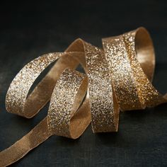 gold glitter ribbon on black background